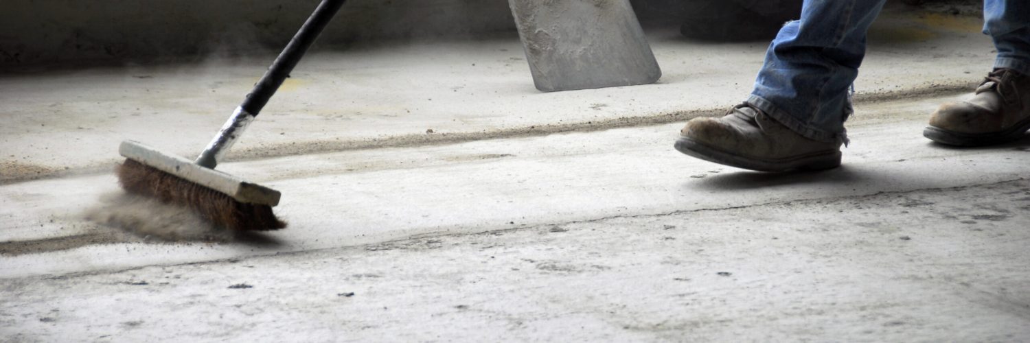 Construction worker sweeping up